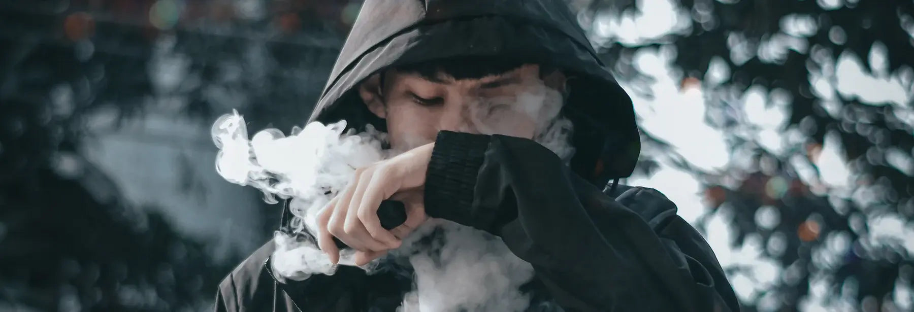 Man in hoodie vaping